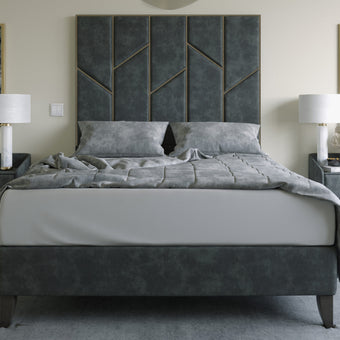 The Chelsea Bed featuring plush upholstery and a unique metal zigzag trim