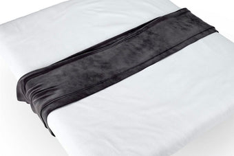 Elegant bed runner with stylish design on a neatly made bed