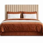 Button Box headboard in striped oat and caramel upholstery