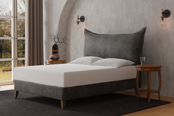 The Berkley Upholstered Bed resembling a large pillow with a French lunar seam, also available as a headboard-only option