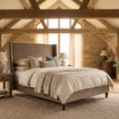 Ashbourne upholstered bed frame styled in an English barn interior