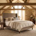 Ashbourne upholstered bed frame styled in an English barn interior