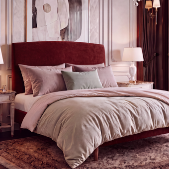 Dreamer king size upholstered bed frame in deep red on slim tapered legs, dressed with a duvet, by The Sleep Co, Quick Ship