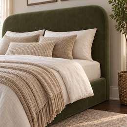 Close up of the Ascot King 5'0 arched headboard and ottoman base upholstered in Velvet Olive